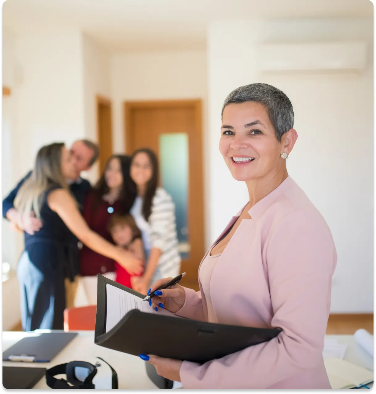 we-are-your-trusted-partner-webp A picture of a trusted realtor with a happy family in the background.