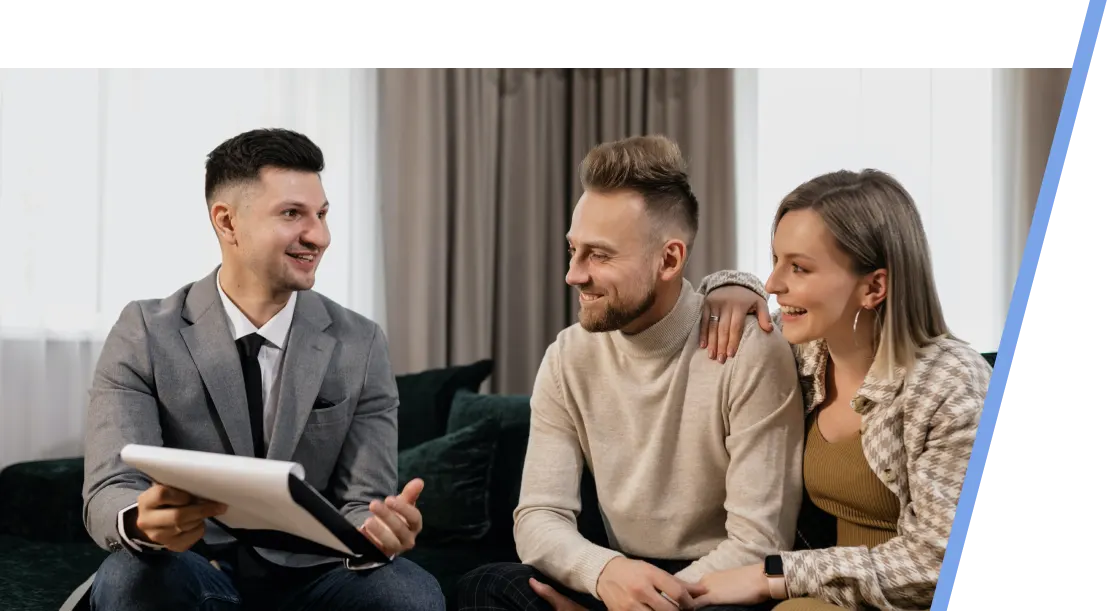 guaranteed-leads-webp An image with a male realtor showing a paper to a couple sitting on a sofa.