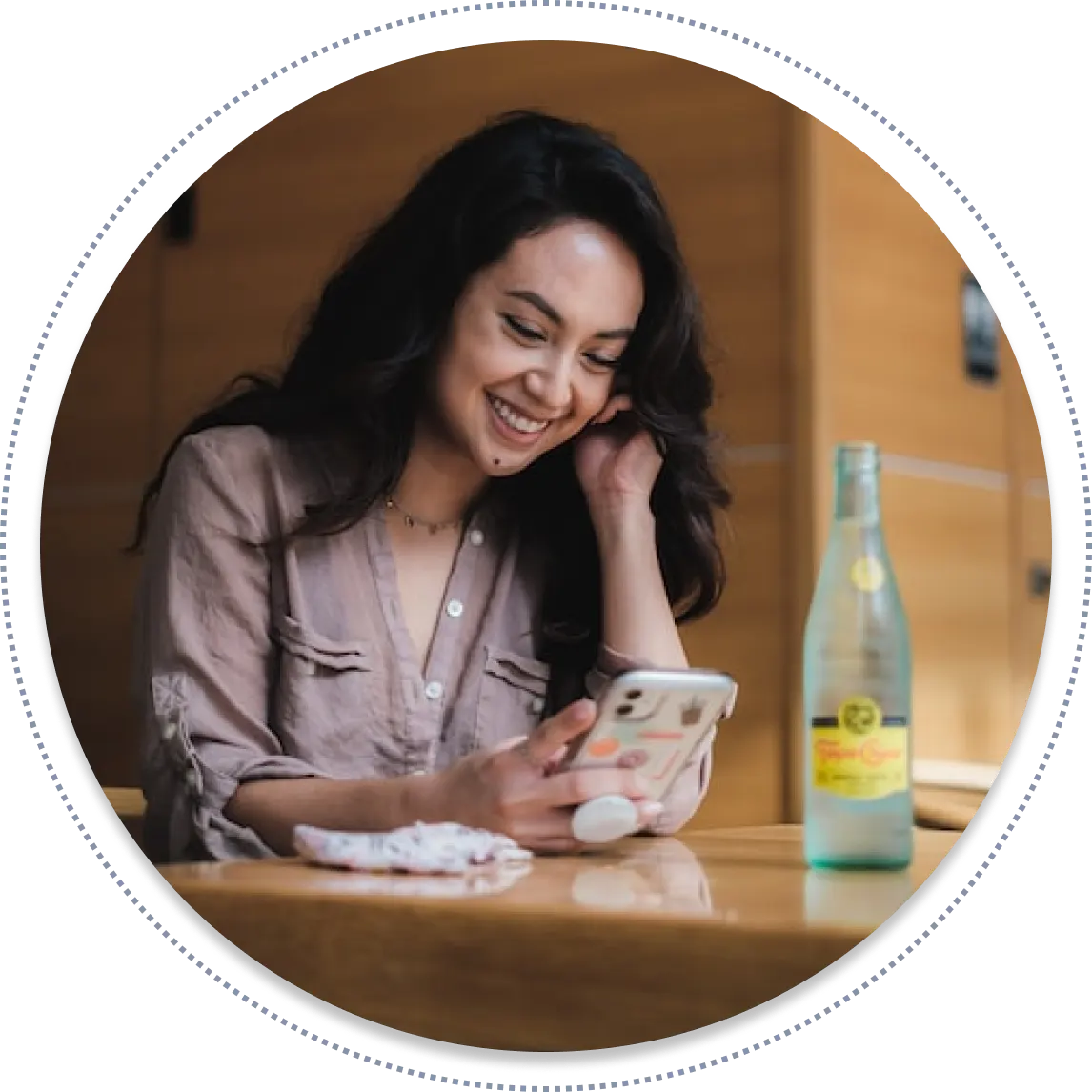ywl-app-download-webp A picture of a lady smiling while looking at her mobile phone.